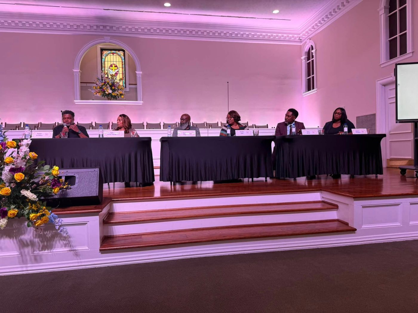 Panel guests seated on stage for the Back to School Mental Health Summit discussion