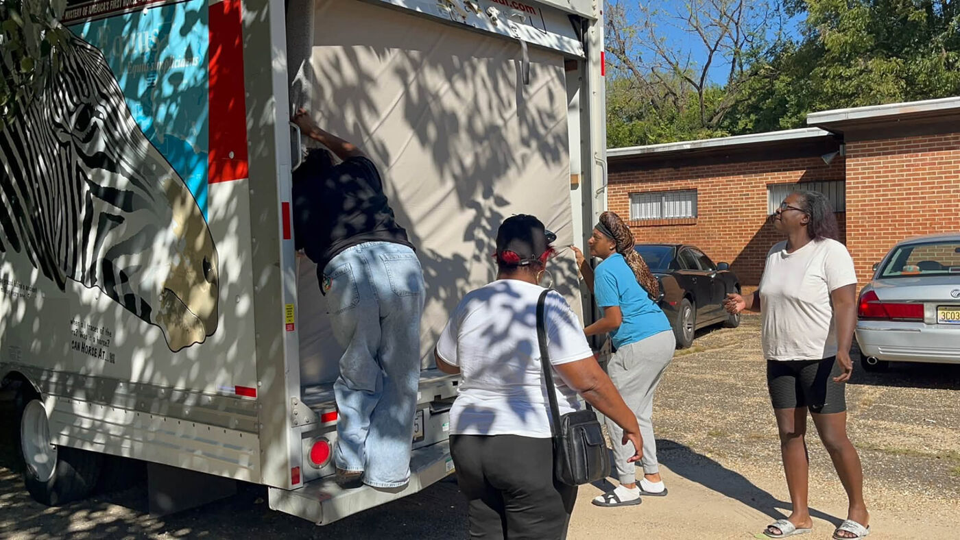Volunteers helping at the back of the truck