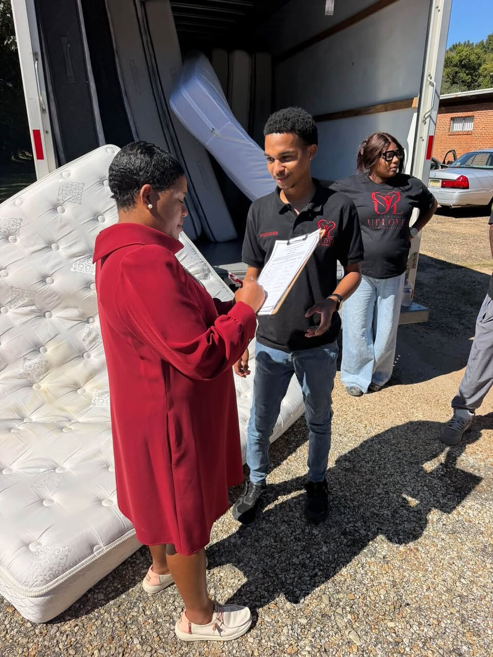 Volunteers checking in a community member next to a mattress