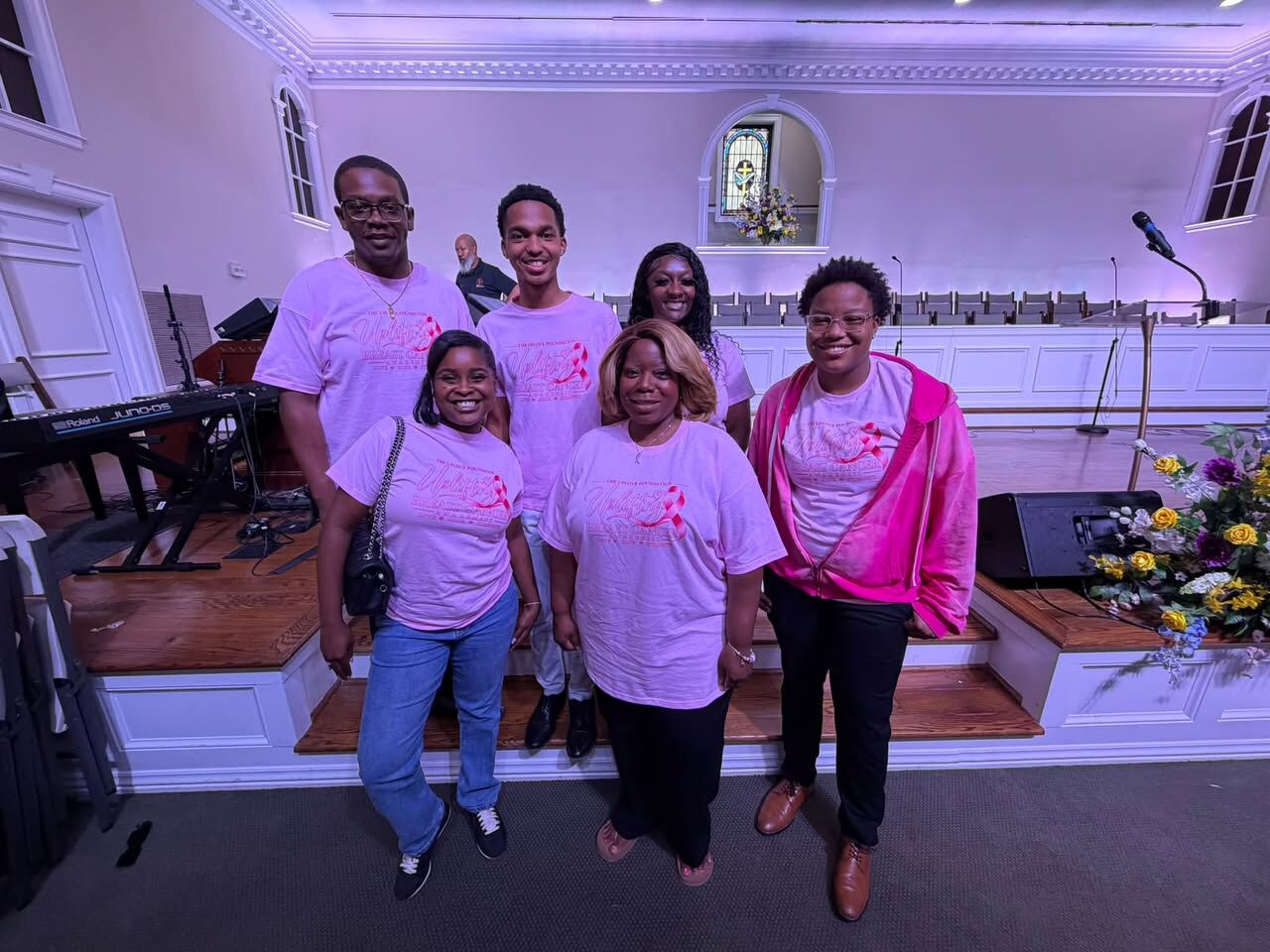 UpLove Foundation members in pink breast cancer awareness shirts at church